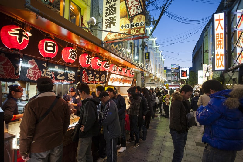 Osaka’s vibrant street food scene is a must-experience on youth trips to Japan, offering delicious local treats like takoyaki, okonomiyaki, and kushikatsu.